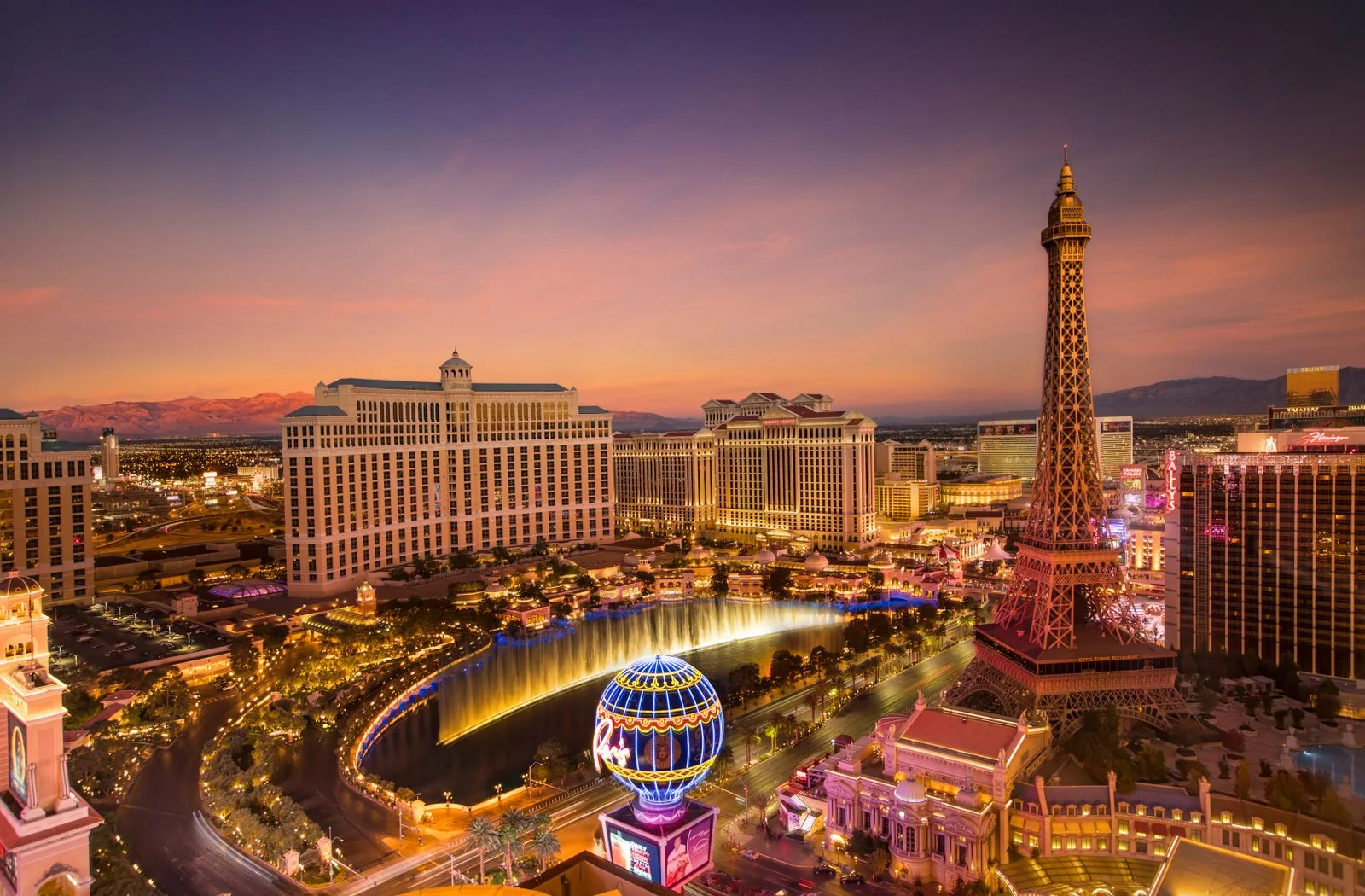 Las Vegas Strip at dusk with Bellagio fountains and the Paris Eiffel Tower
