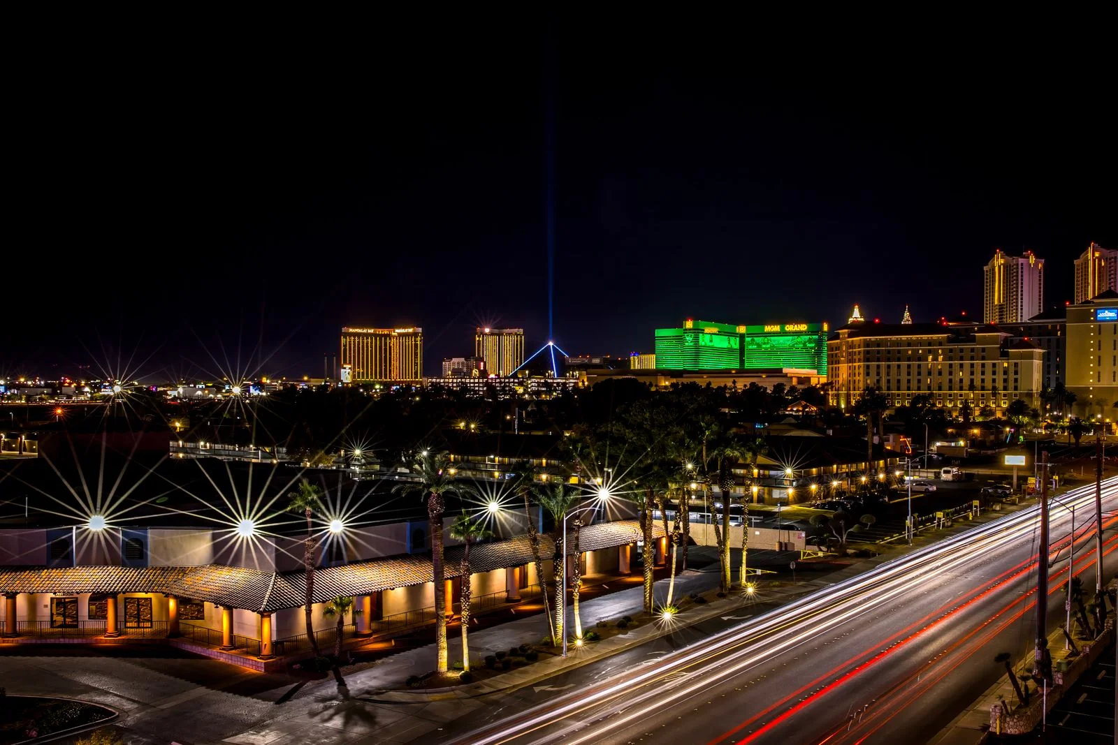 Las Vegas Strip at night with illuminated hotels and traffic light trails